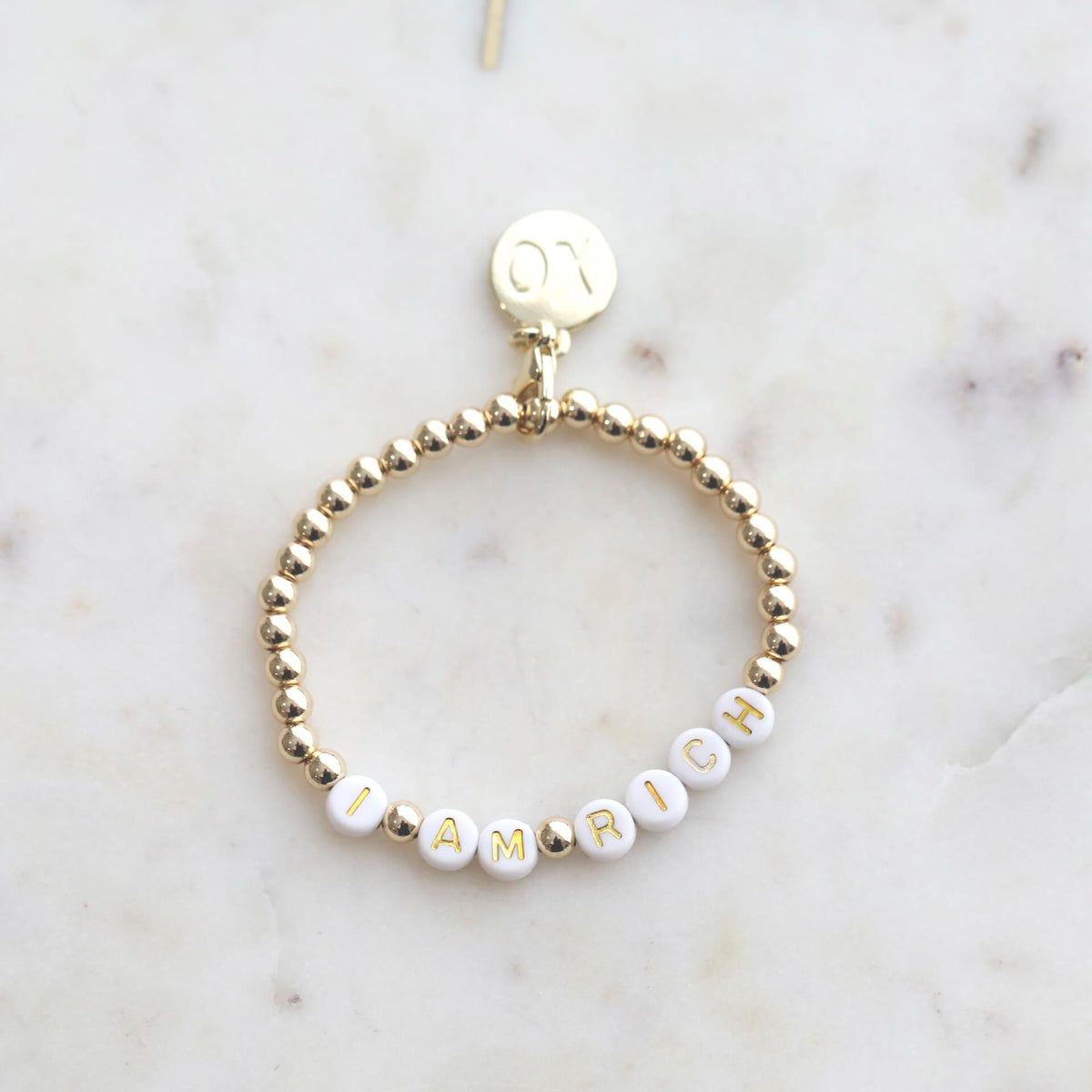 Close-up of 'I AM RICH' Affirmation Bracelet from AGERICH by Mrs V